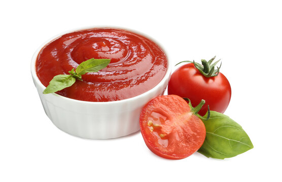 Tasty ketchup in bowl, basil and fresh tomatoes isolated on white