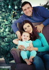 Happy family near the Christmas tree