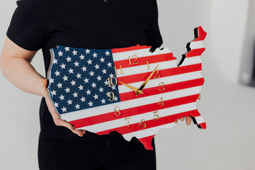 USA map. A clock in the form of a map of America. In hands