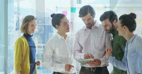 Image of data processing against diverse businesspeople discussing over digital tablet at office