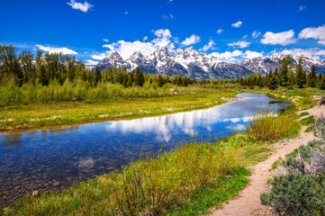 Snake river with a clear view of the Grand Tetons, alongside a walking trail in Schwabacher Landing, Grand Teton National Park, Wyoming, USA.