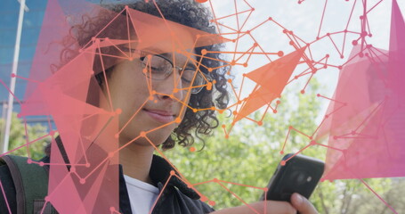 Image of dots connecting with lines forming geometric shapes over biracial man using cellphone
