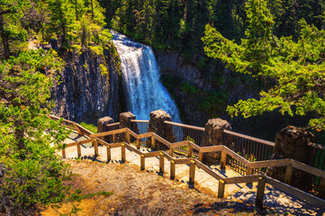 Salt Creek Falls with a wooden railing located within the Willamette National Forest in the Cascade Range of Oregon, USA. It is the second highest waterfall in Oregon, with a drop of 286 feet.