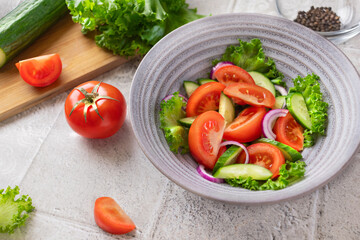 Healthy fitness fresh simple salad. Healthy food Vegetable green salad cucumbers tomatoes onions