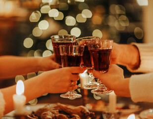 Family friends have fun together in winter eating food on a wooden table