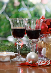 Glasses of red wine and near the Christmas tree