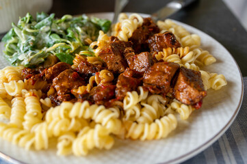 Plate with delicious goulash, hungarian style with pasta.