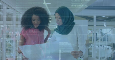 Image of financial data processing over diverse business people discussing work at office