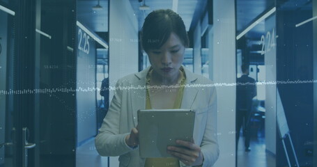 Image of financial data processing over asian businesswoman using tablet in office