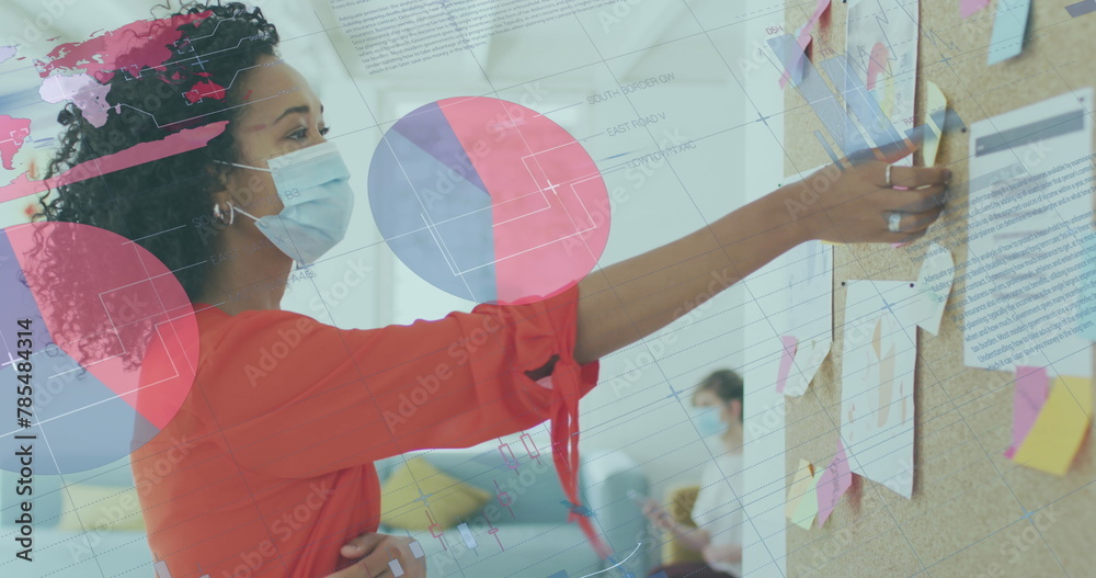 Canvas Prints Image of data processing over biracial businesswoman in face mask in office