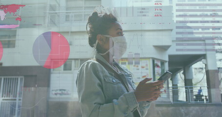 Image of financial data processing over biracial woman in face mask in street
