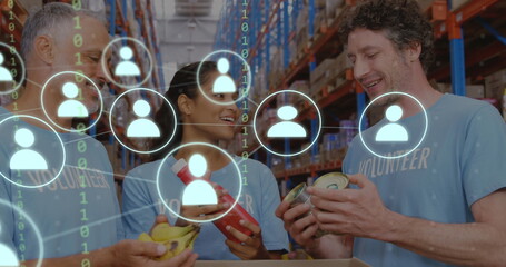 Image of network of icons with binary coding over diverse volunteers in warehouse