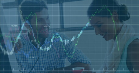 Image of multiple graphs with changing numbers, caucasian coworkers discussing on desk