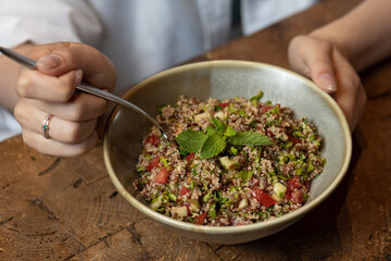 Tabbouleh salad in a bowl on a wooden table .quinoa salad