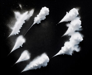 Many white powder explosions on black background