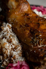 Leg of lamb with rice and red onion on gray background