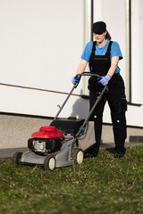 Woman mowing the lawn with a petrol mower