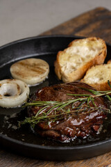 Grilled beef steak with rosemary and toasted baguette