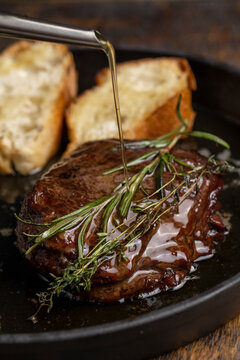 Grilled beef steak with rosemary and toasted baguette