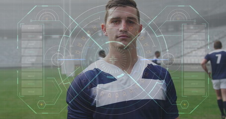 Image of data and statistics over Caucasian male rugby player standing on a pitch digital compositio