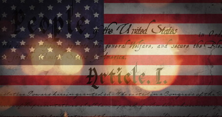 Fototapeta premium Image of out of focus glowing sparkles and american constitution text over american flag