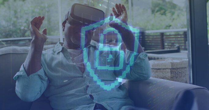 Image of padlock icon and data processing over african american man using vr headset