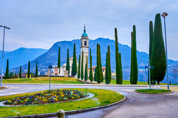 Flowerbed and Sant'Abbondio Chuch on background, Collina d'Oro, Switzerland