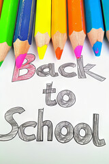 Back to School Handwritten Text with colorful pencils on White Background