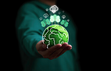 Businessman holding green scrap paper ball with virtual world  trees and carbon reduction icon for absorb carbon dioxide to carbon credit ,limit global warming from climate change concept.