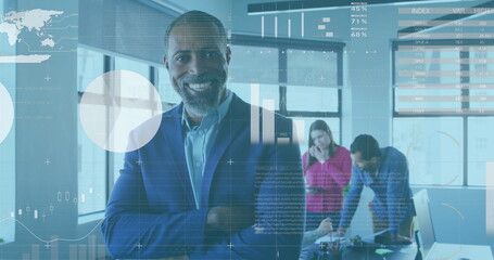 Image of financial data and graphs over happy african american businessman in office - Powered by Adobe