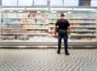 Defocused blur of supermarket shelves with dairy products