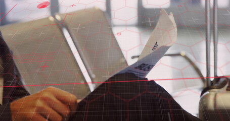 Image of data processing over caucasian businessman with newspaper