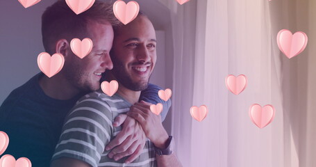 Image of heart icons over diverse gay couple embracing - Powered by Adobe