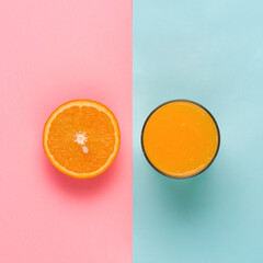 orange juice in glass and half of orange