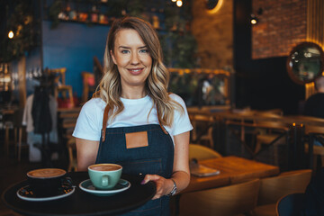 Coffee Business owner Concept - attractive young beautiful  barista with apron in coffee shop....