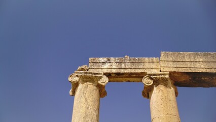 columns holding up stone structure against the sky