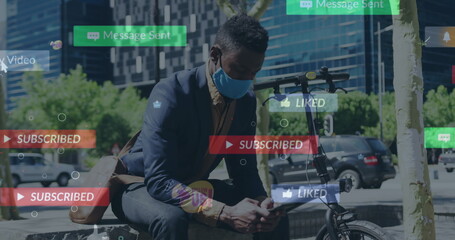 Image of social media notifications over african american businessman with mask using cellphone