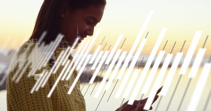 Image of graphs over hands of biracial woman using smartphone