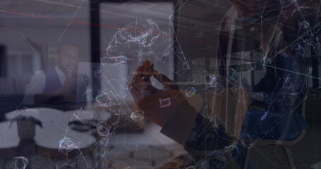 Image of multiracial man eating and colleagues discussing in office over abstract pattern