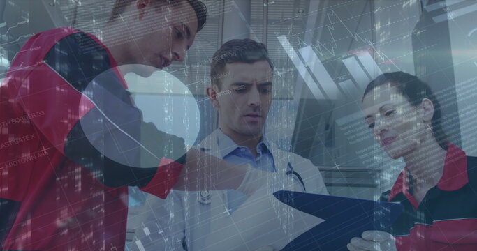 Image of financial graphs and data over caucasian male doctor and medics talking - Powered by Adobe