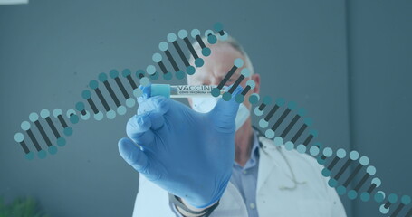 Image of dna strands over caucasian male doctor wearing face mask holding tube with vaccine