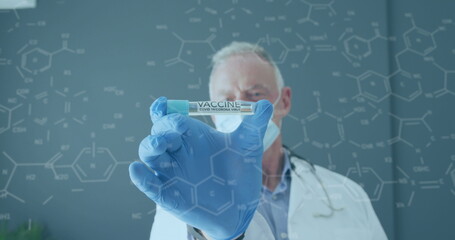Image of chemical formula over caucasian male doctor wearing face mask
