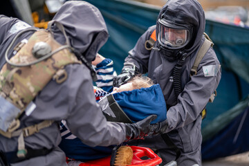 A man in a hazmat suit is helping a child