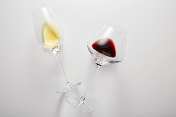 Little red, white wine is poured into stem glasses. - 785527347
