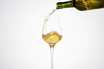 White wine pouring from green bottle, close up. - 785527719