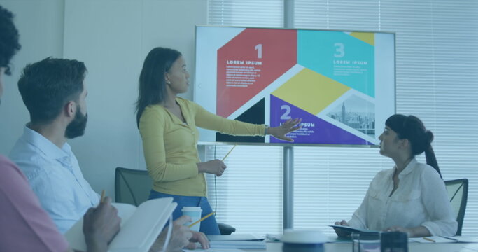 Image of interface with data processing over biracial woman giving a presentation at office