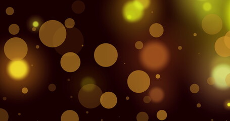 Image of glowing yellow and orange spots of light against black background