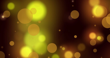 Image of glowing yellow and orange spots of light against black background