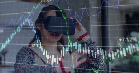 Image of financial data processing over caucasian woman using vr headset