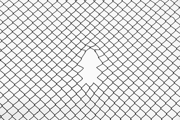 Opening in metallic fence against a blue sky with white clouds. Challenge. uncertainty. breakthrough concept. metaphor. Chain-link, wire netting, wire-mesh, cyclone hurricane fence. - obrazy, fototapety, plakaty
